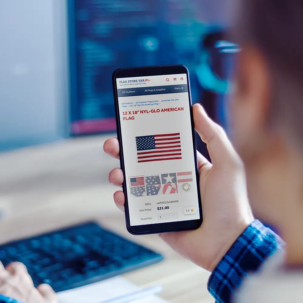 Person holding their smartphone viewing a product page on an ecommerce website.
