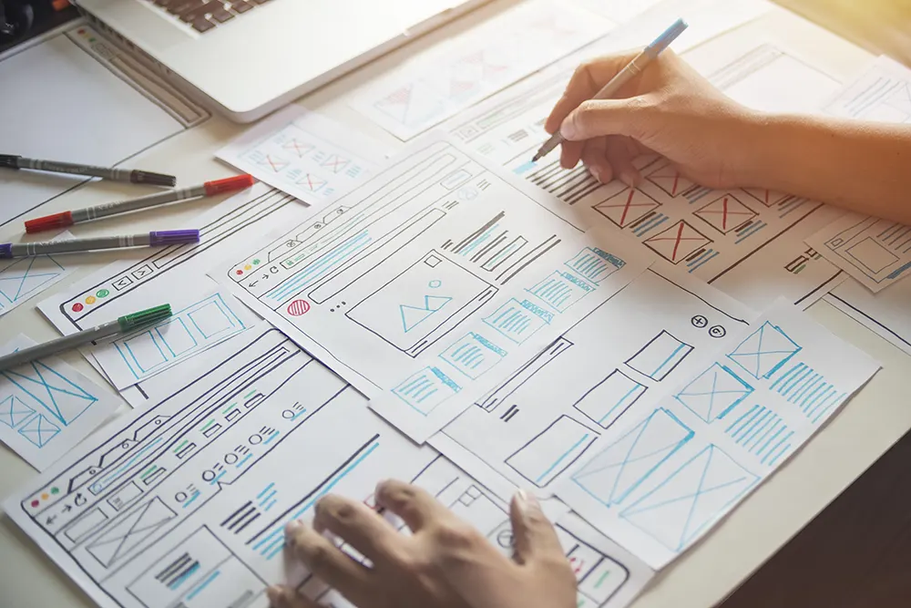 Person working on web design UX wireframes.