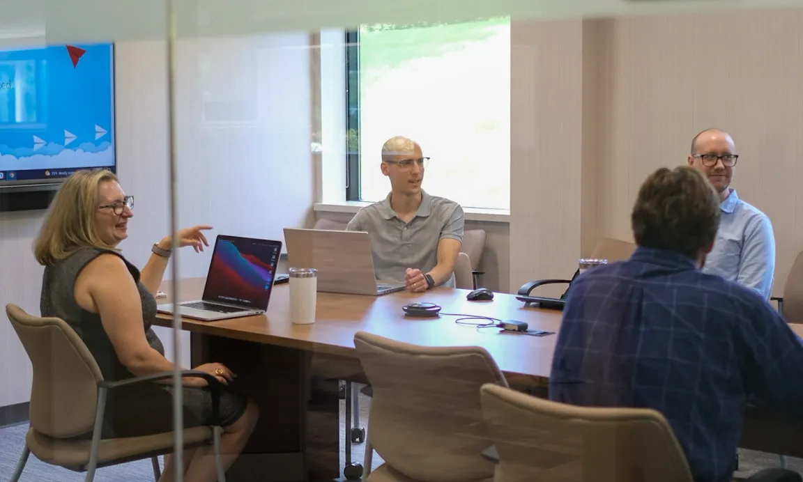 Web design strategy meeting in a conference room.